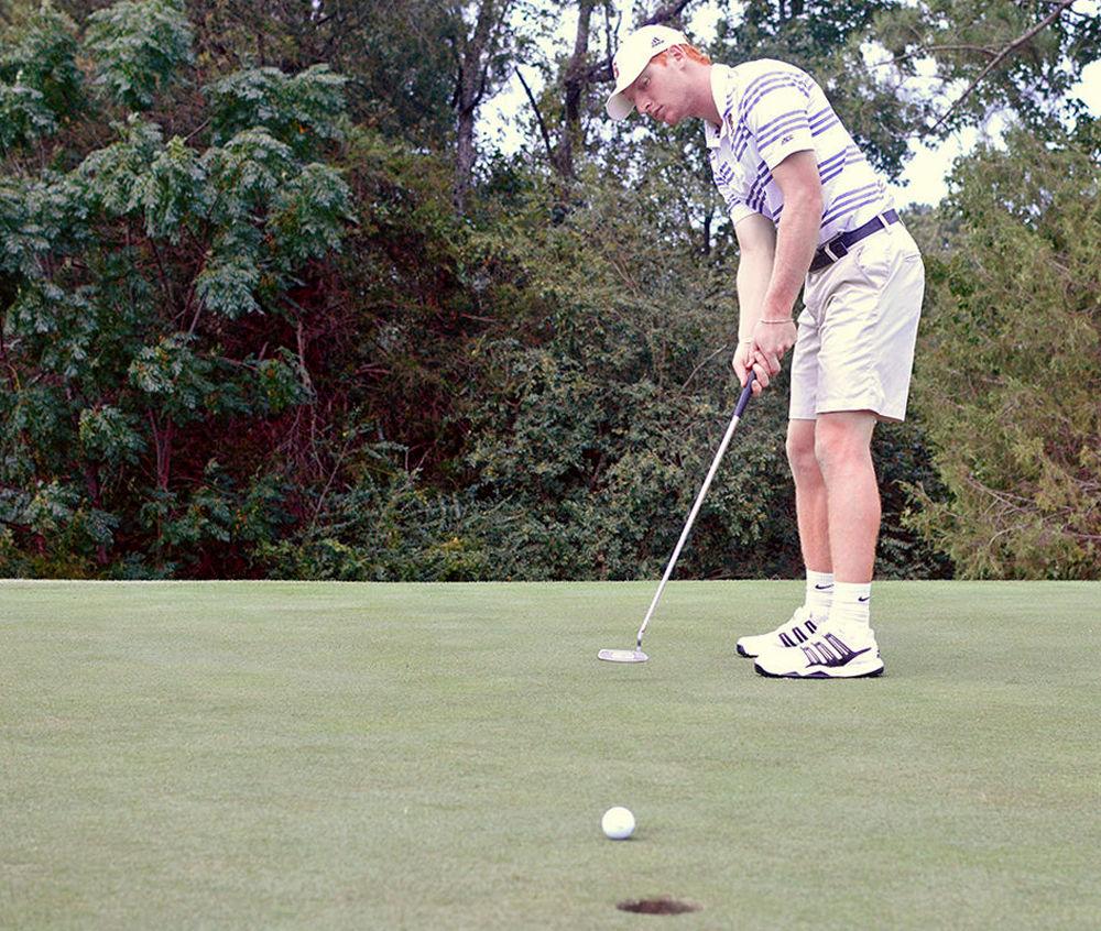 Men's Golf team member Stephen Franken, a senior, warms up before practice at Lonnie Poole Golf Course on Sept. 14, 2017.