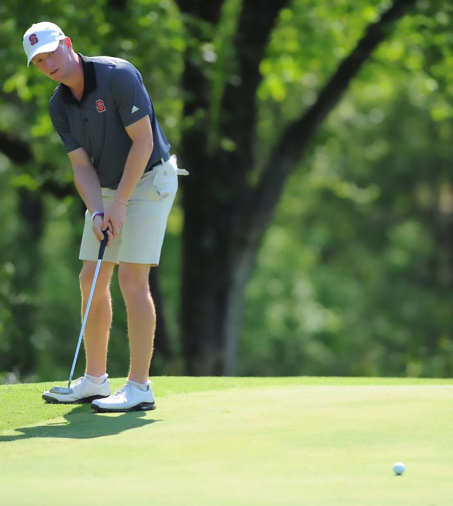 Men's golf team member Stephen Franken putts a golf ball. Franken is a senior from Raleigh studying business administration.