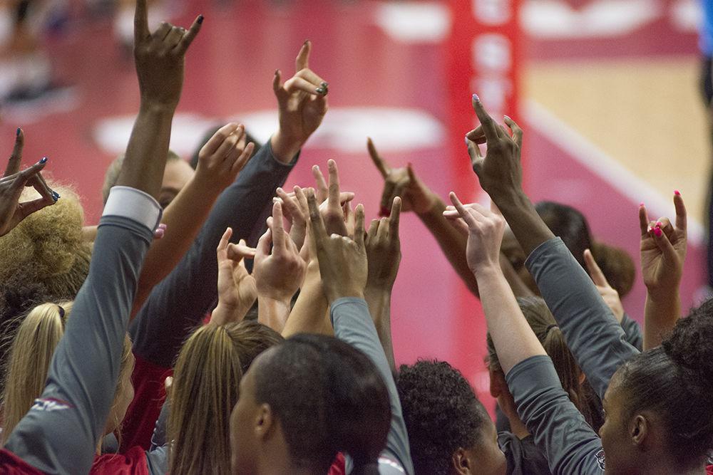 The volleyball team holds up wolfies&#160;during the game against Notre Dame on Sunday, Sept. 23, 2018 at Reynolds Coliseum. The Wolfpack beat the Fighting Irish 3-1 for their first ACC win.