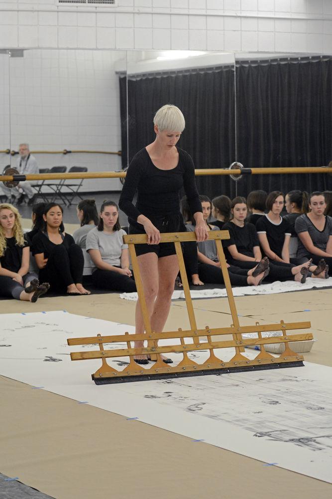 Justin Tornow, a dancer and choreographer based in Durham, NC, adds a finishing coat of paint to her composition of "John Cage's STEPS" during a Master Class in Carmichael Gymnasium on Wednesday, Sept. 19.