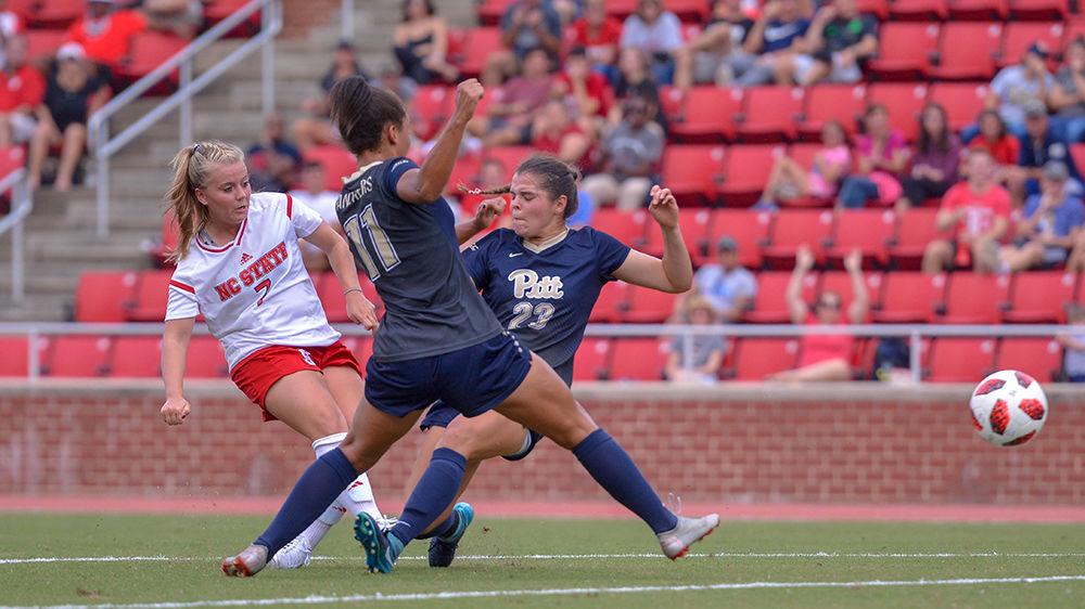 Junior midfielder Ricci Walkling shoots between the Pittsburgh defense and scores on Sunday, Sept. 23, 2018 in Dail Soccer Stadium. Walkling scored twice against the Panthers and had one assist. The Wolfpack beat the Panthers 6-0.
