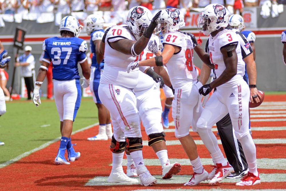 Redshirt senior offensive guard Terronne Prescod celebrates with redshirt freshman wide receiver Thayer Thomas on Saturday, Sept. 8 at Carter-Finley Stadium. Thomas had 114 receiving yards and 1 touchdown as the Wolfpack beat Georgia State 41-7.