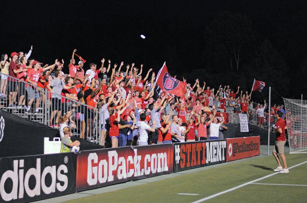 The NC State soccer student section stand and cheer as the athletics staff throw free t-shirts into the crowd during the game against William &amp; Mary on Monday, Sept. 3. NC State prevailed over William and Mary in a 2-1 win for the Wolfpack in overtime.