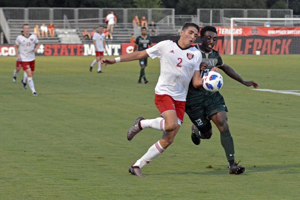 Sophomore forward Manny Perez battles for the ball against William &amp; Mary at Dail Soccer Stadium on Monday, Sept. 3. The Wolfpack won 2-1 in overtime.