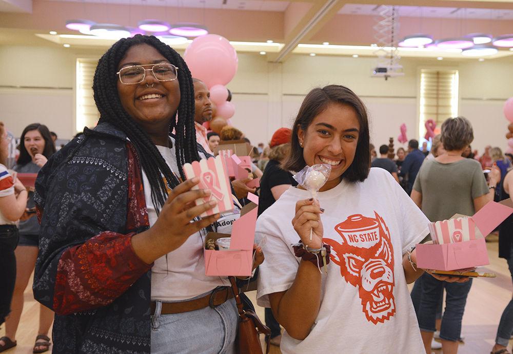 Cindy McCalvin and Brenna Copeland, a sophomore in First Year Engineering, smile for a picture at the 2018 Chocolate Festival in Talley Ballroom, on Friday, Sept. 28. The Chocolate Festival is an annual event hosted by the NC State Women's Center to benefit the Kay Yow Cancer Fund.