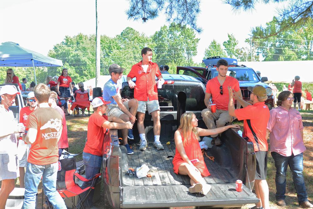 A group of NC State students hang out together at a tailgate during parents and familes weekend on&#160;Saturday, September 16th, 2017.&#160;There were 56,166 people in attendance of the game against Furman, and NC State won 49-16.