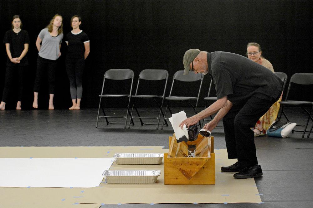 Ray Kass, an artist and the founder of Mountain Lake Workshop, pours black paint into a trough in preparation of the Master Class performance of "John Cage's STEPS: A Composition For A Painting" on Wednesday, Sept. 19 in Carmichael Gymnasium.