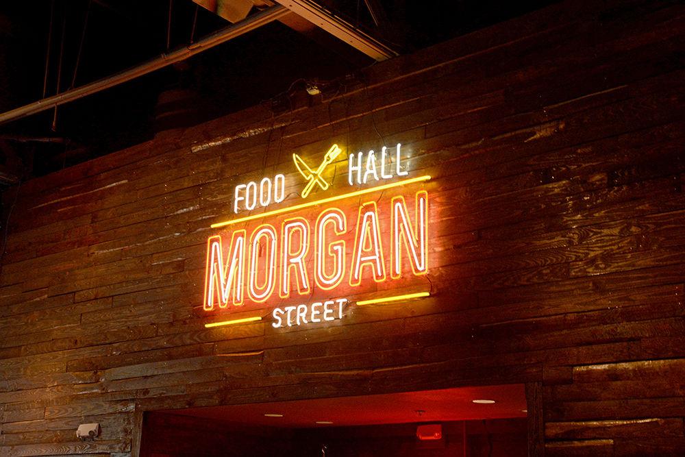 A neon sign hangs in Morgan Street Food Hall on Sunday, Sept. 9 in downtown Raleigh's Warehouse District.