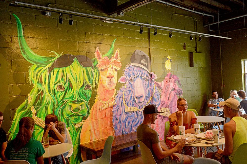 Customers enjoy food and drinks at Morgan Street Food Hall in downtown Raleigh on Sunday, Sept. 9. Morgan Street Food Hall opened this summer and offers a wide variety of vendors and eateries for customers to enjoy.