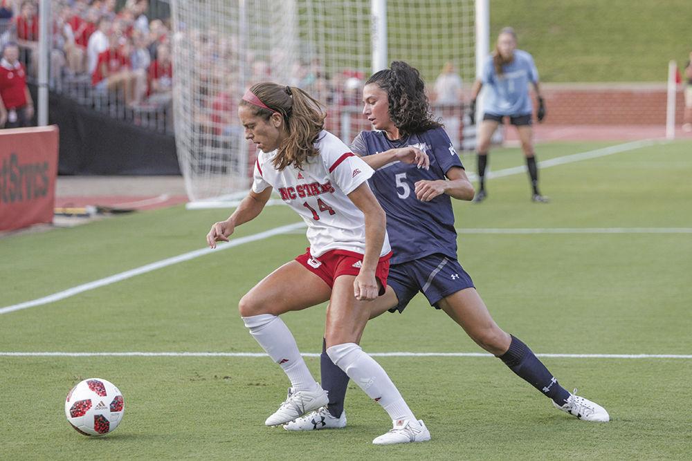 Senior midfielder Taylor Porter fights for possession of the ball near the goal line during the 1-0 golden goal win over Monmouth University in the second period of overtime on Monday, Aug. 20 at Dail Soccer Stadium.