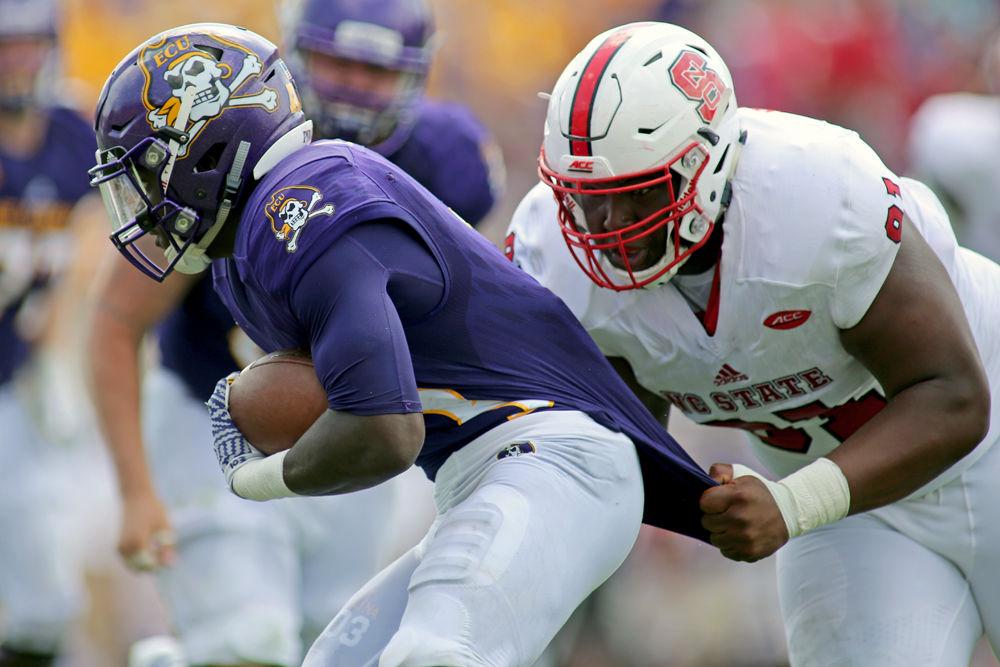 Senior defensive tackle Eurndraus Bryant tackles ECU&#8217;s Anthony Scott on Sept. 10, 2016 at Dowdy-Ficklen Stadium. The Wolfpack lost to the Pirates 30-33.
