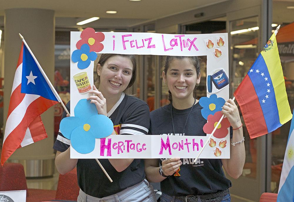 Mariana Andreu-Sanz, a fourth-year studying anthropology, and Valentina Quintero, a fourth-year studying environmental technology and management, hold a promotional poster along with the Puerto Rican and Venezuelan flags at Latinx Heritage Month Kickoff on Friday, Sept. 21, 2018 in Talley Student Union. At the event, Andreu-Sanz and Quintero represented Lambda Pi Chi, a sorority that promotes the Latina community's presence on campus.