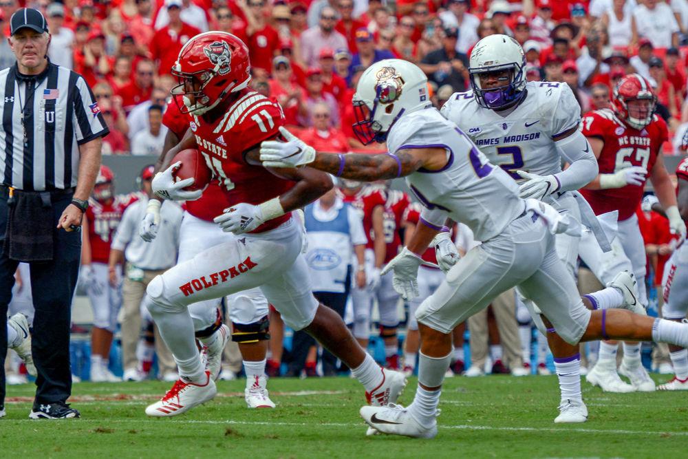 Redshirt junior wide receiver Jakobi Meyers rushes past James Madison defenders on Saturday, Sept. 1 in Carter Finley Stadium. Meyers had 161 receiving yards versus JMU and the Wolfpack won the game 24-13.