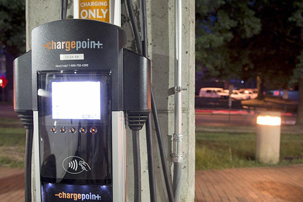 An electric car-charging station stands in the Dan Allen parking deck on Sunday, Aug. 14, 2016. These stations require an electric vehicle parking permit and have four-hour charging limits from 7 a.m. to 5 p.m.