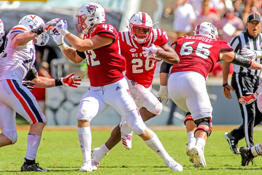 Freshman running back Ricky Person Jr. squeezes through a hole in the offensive line for a 38 yard gain on Saturday, Sept. 29 in Carter-Finley Stadium. Person Jr. finished the game 108 yards on 14 carries as the Wolfpack beat Virginia 35-21.