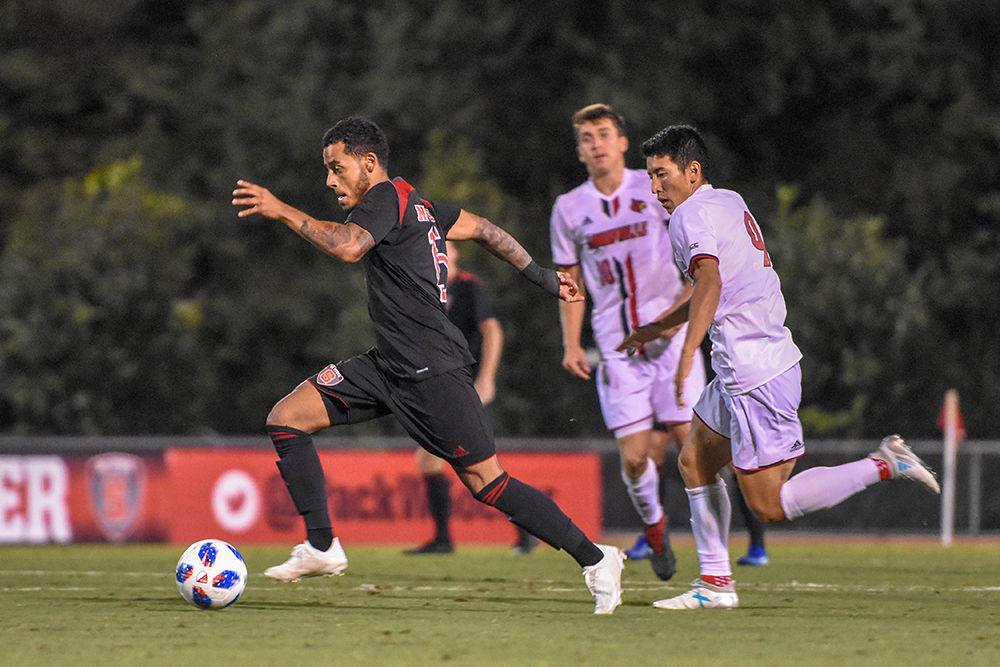 Junior midfielder Gabriel Machado&#160;dribbles past the Louisville defense before scoring last Friday, Sept. 28 at Dail Soccer Stadium. The Wolfpack tied the Cardinals 2-2 after double overtime.