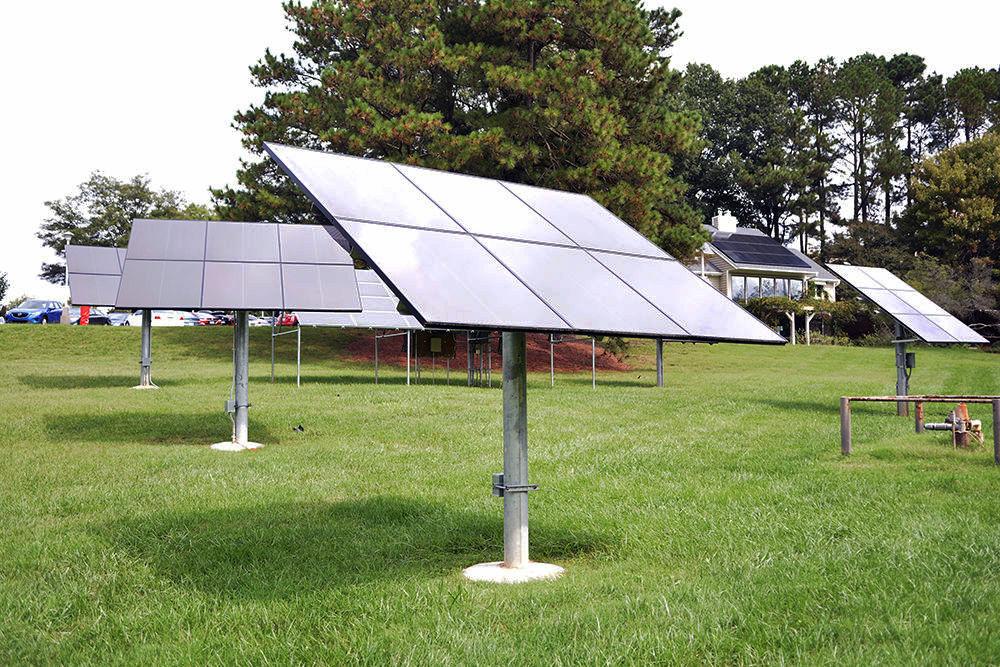 Solar panels installed by the North Carolina Clean Energy Technology Center sit outside of the Solar House at the McKimmon Center.