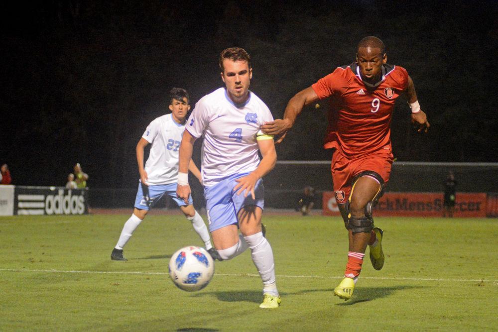 Redshirt senior forward Ade Taiwo chases the ball at Dail Soccer Stadium on Friday, Oct. 12. The Wolfpack beat No. 1 UNC-Chapel Hill 1-0.