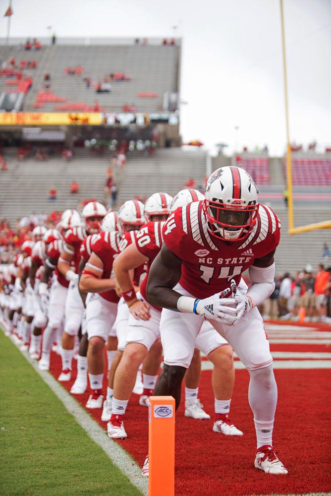 Redshirt senior safety Dexter Wright leads his teammates in warm-up drills before playing Boston College on Saturday, Oct. 6 at Carter-Finley Stadium. The Wolfpack won 28-23.