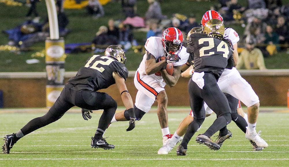 Senior halfback Jaylen Samuels runs behind his blockers during the heartbreaking 30-24 loss to Wake Forest on Saturday, Nov. 18 at BB&amp;T field.
