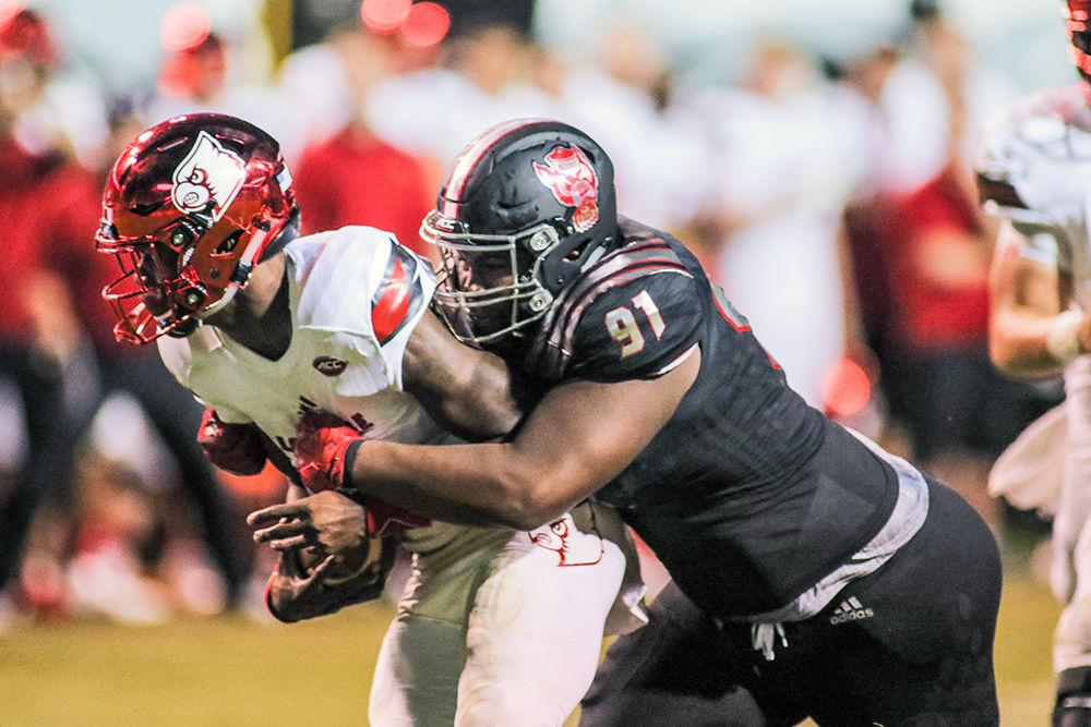Junior defensive tackle Eurndraus Bryant hits quarterback Lamar Jackson. The Wolfpack took down Louisville 39-25 in Carter-Finley Stadium on Oct. 5, 2017. Bryant had a major impact on defense, with two sacks for 13 yards.