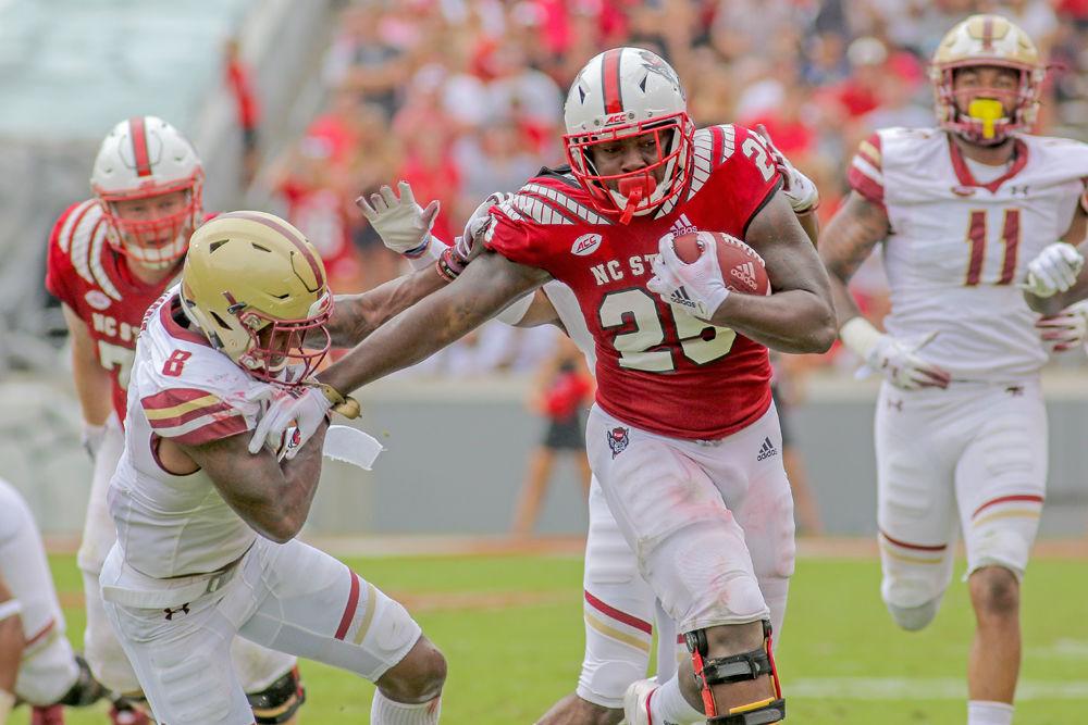 Senior running back Reggie Gallaspy Jr. stiff arms Boston College defensive back Will Harris on Saturday, Oct. 6 in Carter-Finley Stadium. Gallaspy totaled 104 yards on 25 carries as the Wolfpack survived Boston College 28-23.