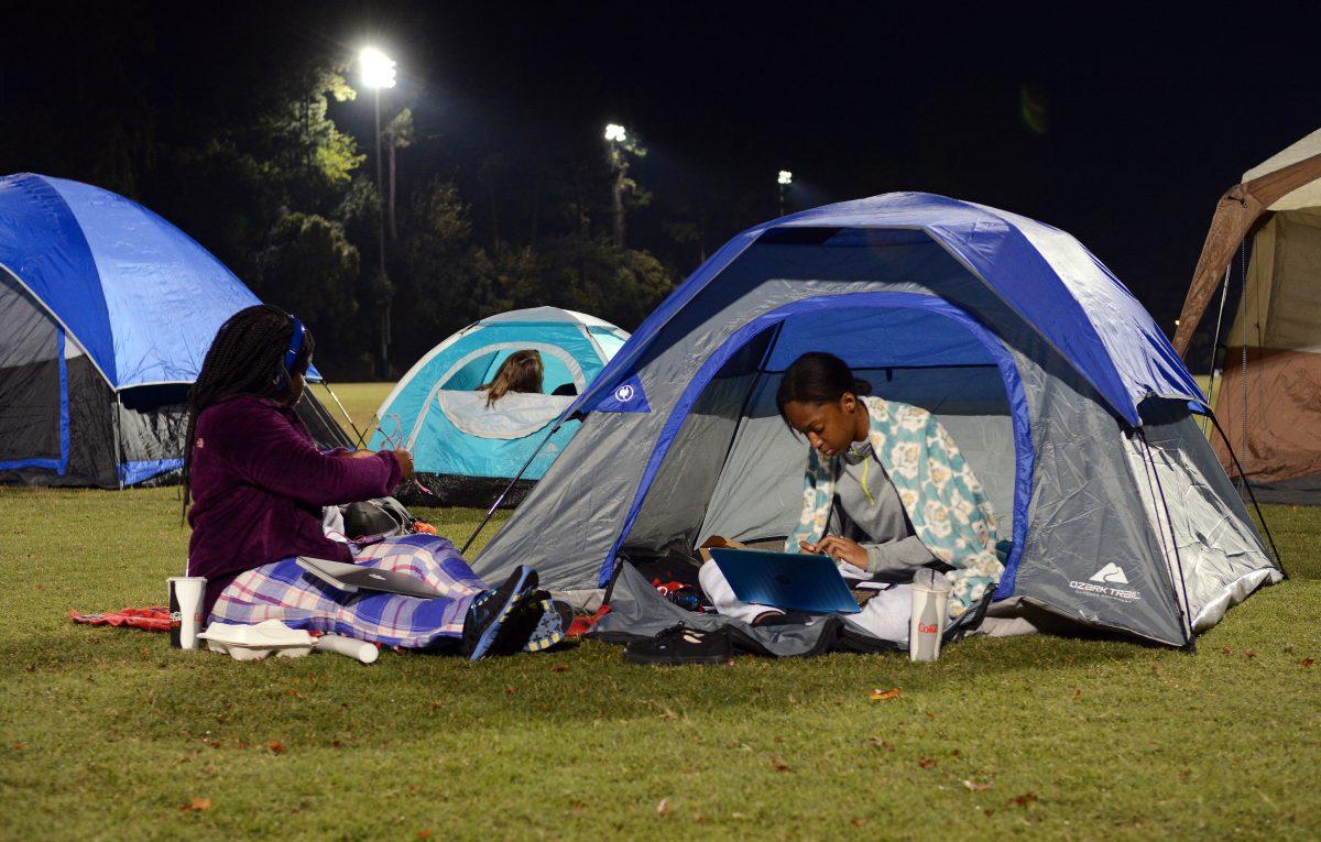 Jenay Brown, a first year studying engineering first year, and Dejha Nixon, also a first year studying engineering first year, study outside of their tent at Campout on Miller Fields on Friday, October 20, 2017.