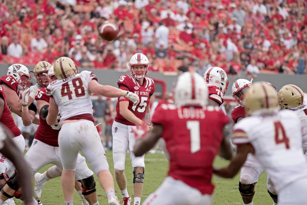 Graduate quarterback Ryan Finley threads a pass to graduate wide receiver Stephen Louis on Saturday, Oct. 6 at Carter-Finley Stadium. The Wolfpack ended up winning 28-23.