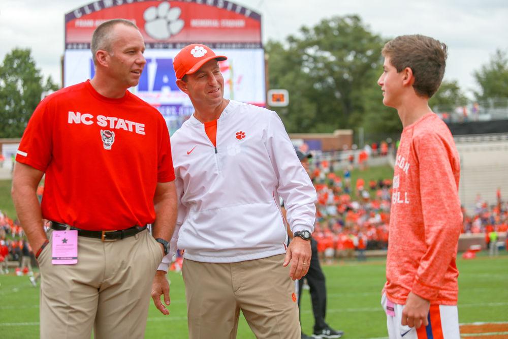 Head coaches Dave Doeren and Dabo Swinney get together to talk with Swinney's youngest son Clay before the 41-7 loss to Clemson at Clemson Memorial Stadium on Saturday, Oct. 20.