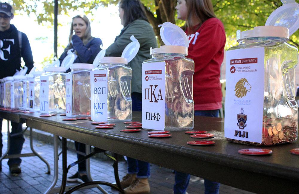 Jars are set up for different organizations to compete in penny wars for Red and White Week in Wolf Plaza on Monday, Oct. 29. The jars were filled during the week, and all of the profits went towards the Student Emergency Fund.