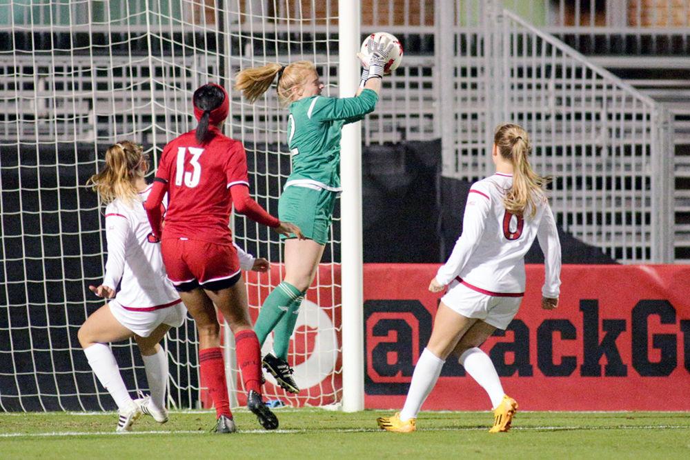 Junior goalkeeper Sydney Wootten grabs the ball out of the air for a save. Wootten had six saves on the day. The Wolfpack soccer team came away with a 2-1 win over Louisville to clinch the third seed for the ACC tournament on Oct. 26 in Dail Soccer Field.