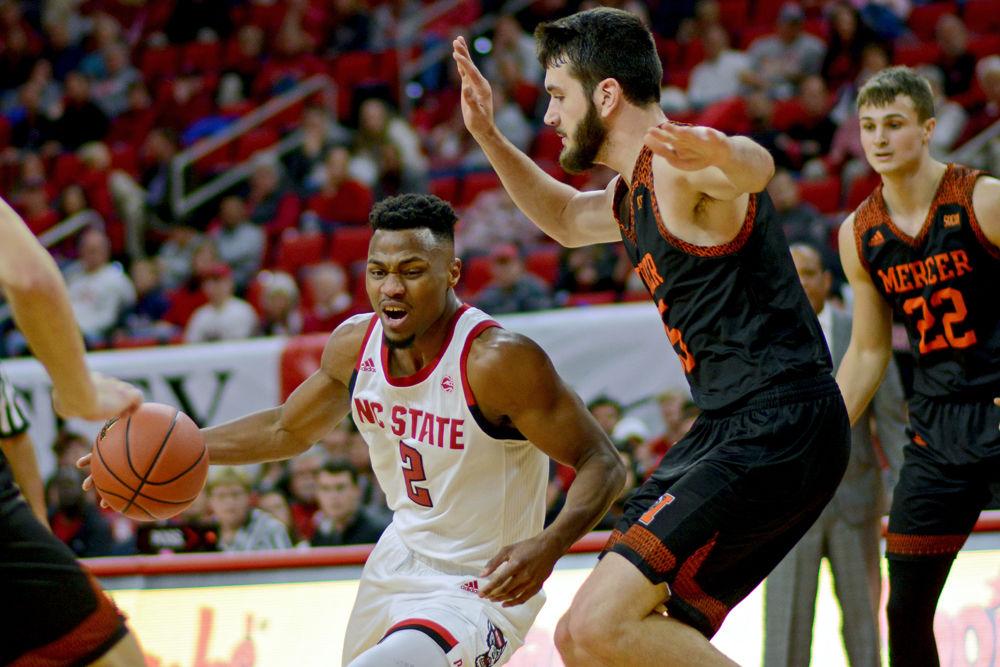 Redshirt senior guard Torin Dorn attacks the Mercer defense on Saturday, Nov. 24 at PNC Arena. Dorn scored 19 points on 7-15 shooting along with nine rebounds as the Wolfpack won 78-74.