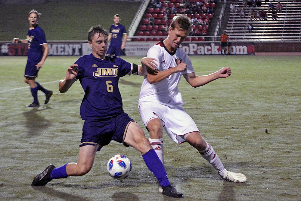 Senior forward Tanner Roberts[BW1]&#160; fights for the ball with a James Madison defender during the soccer match on Tuesday, Oct. 2 in Dail Soccer Stadium. The No. 17 Wolfpack tied with the Dukes 0-0.