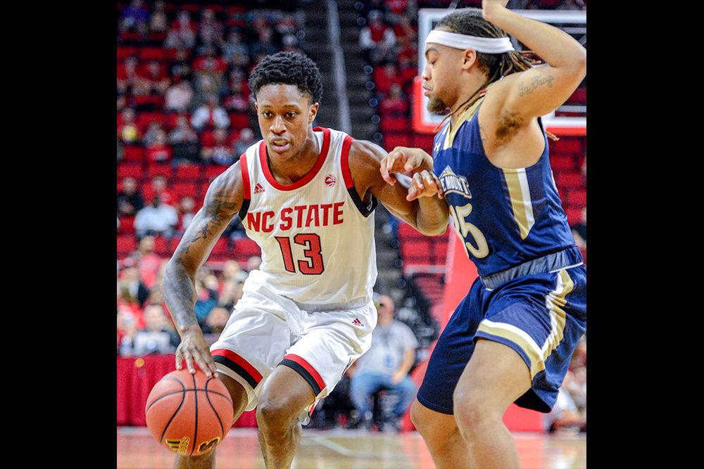 Redshirt junior guard C.J. Bryce drives against Mount St. Mary's guard/forward K.J. Scott on Tuesday, Nov. 6 in PNC Arena. Bryce recorded 16 points and four steals as the Wolfpack beat the Mountaineers 105-55.