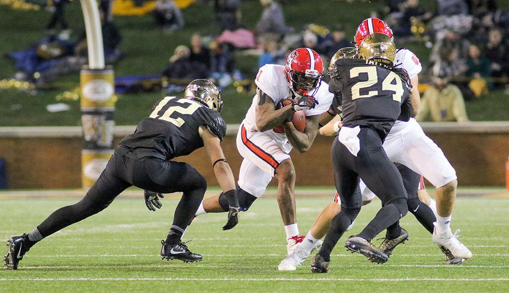 Senior halfback Jaylen Samuels runs behind his blockers during the heartbreaking 30-24 loss to Wake Forest on Saturday, Nov. 18 at BB&amp;T field.