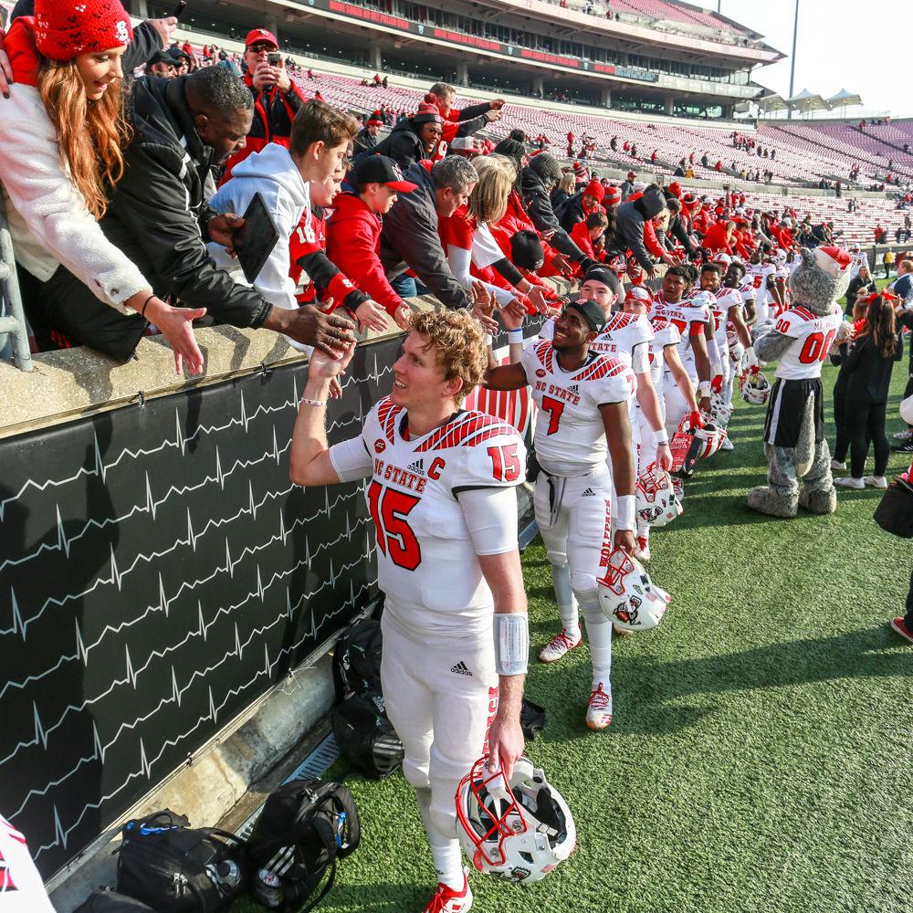 The team takes time to high-five fans after the 52-10 rout of Louisville on Saturday, Nov. 17 in Cardinal Stadium.