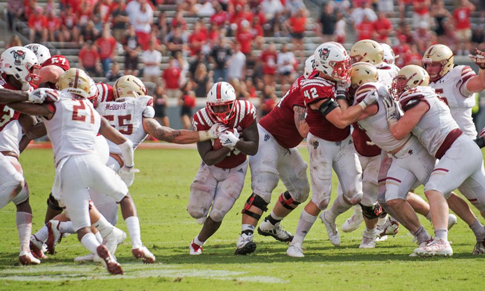 Running Back Reggie Gallaspy Jr. breaks through a tackle by Boston College&#8217;s James McDuffie at Carter Finley Stadium. The senior had a heavy workload on the day, racking up 104 yards on 25 carries.