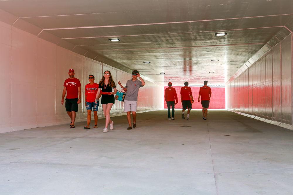Fans walk through the recently opened tunnel that runs below Trinity Road on Saturday, Sept. 29. Fans used the tunnel to go to Carter-Finley Stadium to watch the football game between NC State and Virginia, which the Wolfpack won 35-21.