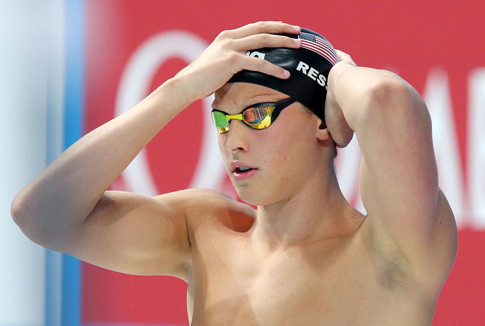 Senior Justin Ress adjusts his swim cap before an event. Ress studies applied math and hails from Cary.