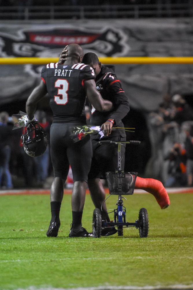 Graduate wide receiver Stephen Louis and graduate linebacker Germaine Pratt embrace on senior night against Wake Forest &#160;on Thursday, Nov. 8 in Carter-Finley Stadium. The Wolfpack lost 27-23.