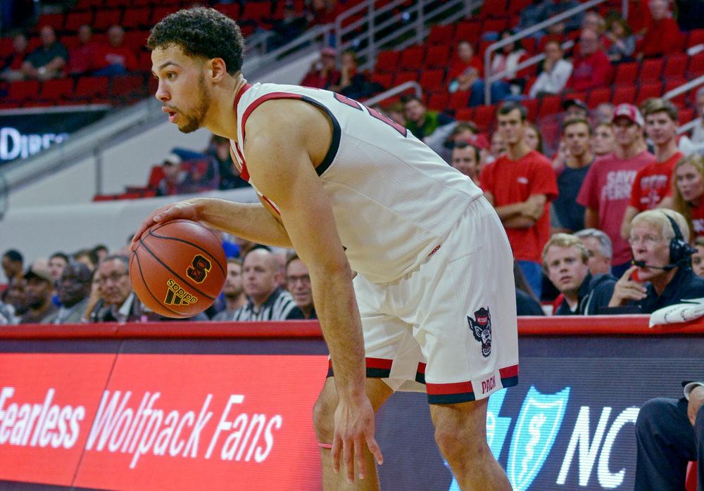 Redshirt sophomore guard Devon Daniels scans the floor on Tuesday, Nov. 13 at PNC Arena. Daniels scored 20 points on 8-16 shooting along with nine rebounds as the Wolfpack beat UNC Asheville 100-49.