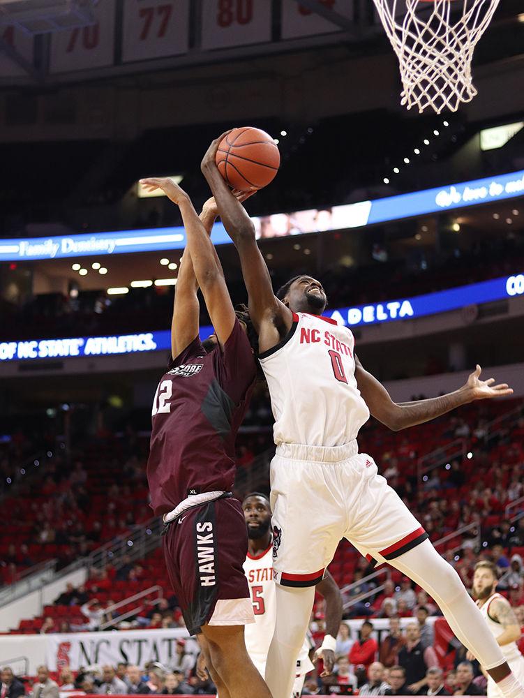 Redshirt sophomore forward DJ Funderburk goes up for a defensive rebound in PNC Arena on Saturday, Nov. 10. Funderburk had 5 total rebounds along with 13 points as the Wolfpack won 95-49.