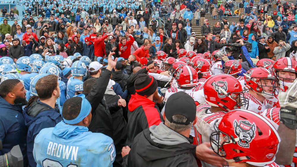 The two teams are separated after a scuffle at the end of the 34-28 overtime win over UNC on Saturday, Nov. 24 in Kenan Memorial Stadium.