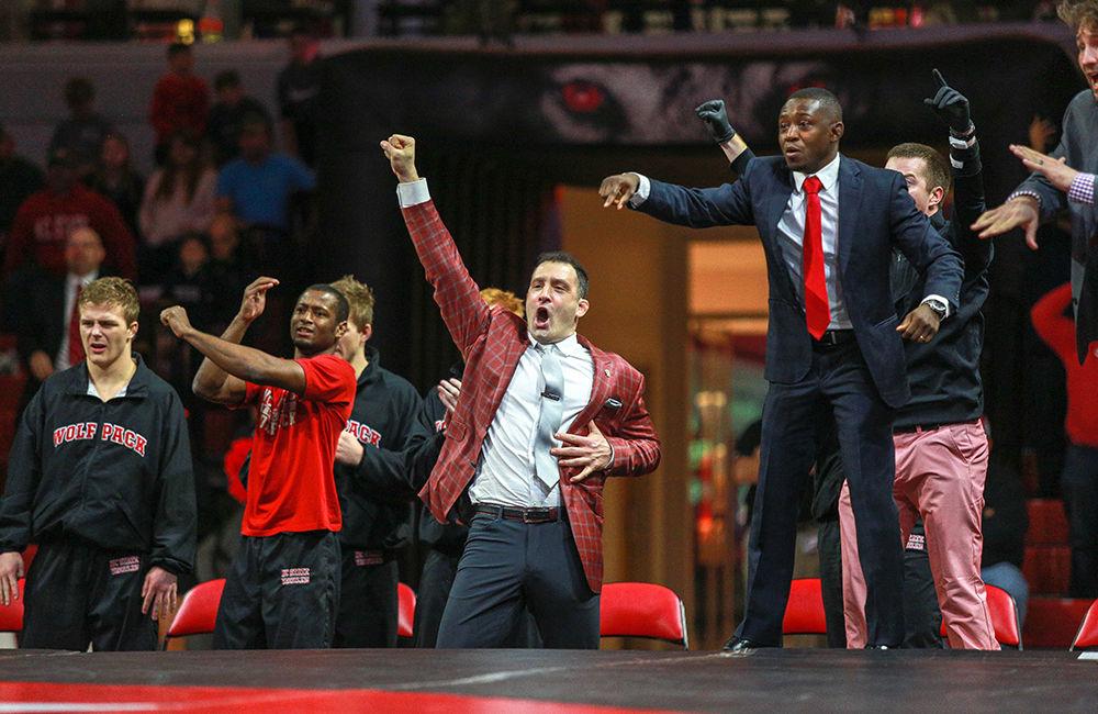 Head coach Pat Popolizio and the rest of the bench cheer at the dominant performance of redshirt sophomore Tariq Wilson, who ended the day with an 18-2 technical fall. The No. 7 Wolfpack were able to defeat No. 11 Nebraska by tying the score int he last bout and finishing 18-17 on Sunday, Dec. 16 in Reynolds Coliseum.