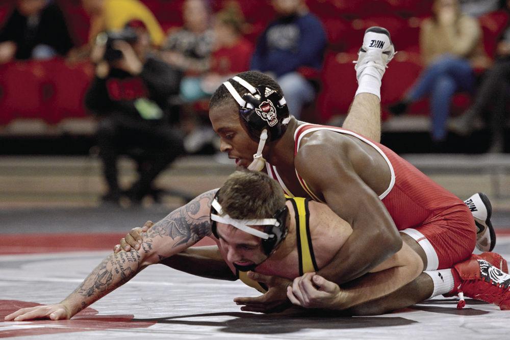 NC State player Tariq Wilson wins 5-2 over Appalachian State&#8217;s Codi Russell in Reynolds Coliseum on Dec. 4 this Tuesday. The Wolfpack won the dual 29-9.