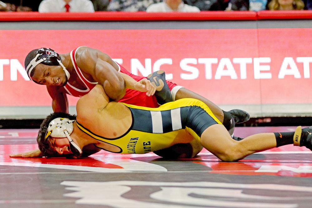 Redshirt senior Jamal Morris holds down Appalachian State's Irvin Enriquez at Reynolds Coliseum on Dec. 4, 2018. Morris won the bout with a 10-4 victory, increasing the lead over the Mountaineers 10-0.