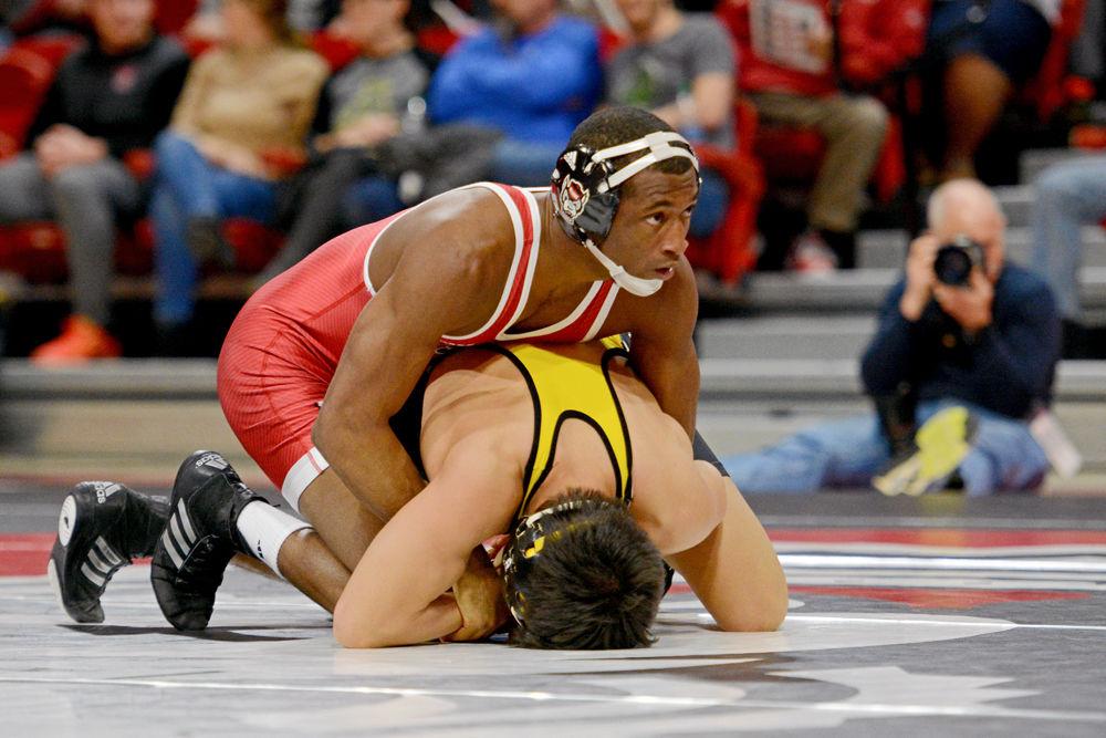 Redshirt senior Jamal Morris holds down Appalachian State&#8217;s Irvin Enriquez at Reynolds Coliseum on Tuesday, Dec. 4, 2018. The Wolfpack won over Appalachian State 29-9.