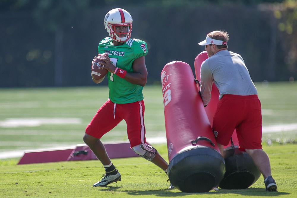 Former Offensive Coordinator and Quarterbacks Coach Eliah Drinkwitz runs a drill with redshirt freshman quarterback Matthew McKay during practice on Thursday, Aug. 9.