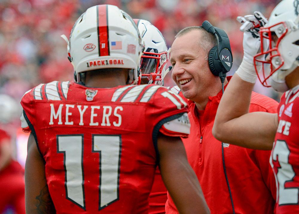 NC State head football coach Dave Doeren celebrates with redshirt junior wide receiver Jakobi Meyers&#160;after Meyers broke the NC State record for most receptions in a season on Saturday, Dec. 1, 2018 in Carter-Finley Stadium. The Wolfpack beat the Pirates 58-3.