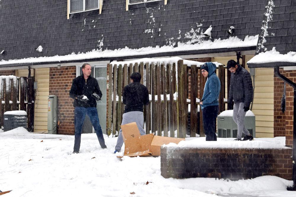Residents of Kings Court play with snow on Sunday, Dec. 9. Students enjoyed their first snowfall of the season as Monday morning exams were postponed.&#160;